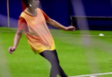 Woman playing walking soccer on an indoor field
