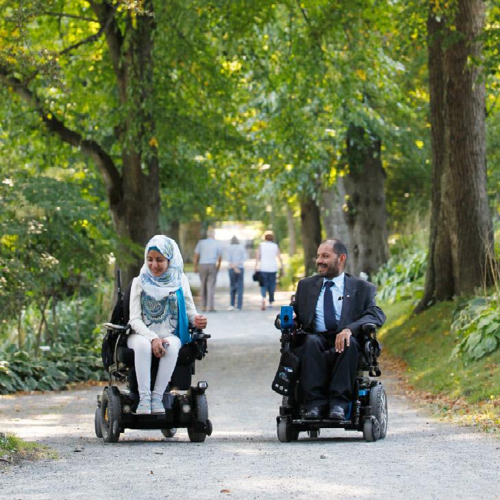 Marwa Harb and her father Mohammad, who both use power wheelchairs, in a park
