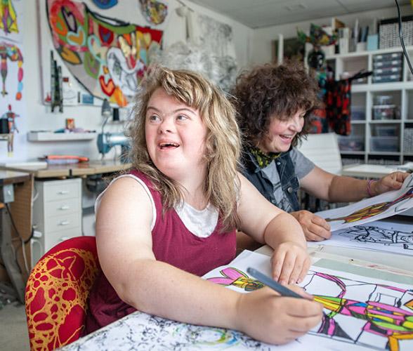 Marie Webb, an artist with Down syndrome, working on a drawing
