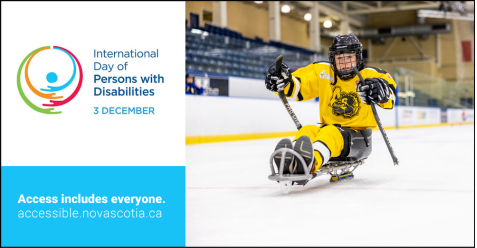 A young child in a yellow hockey uniform plays sledge hockey on ice.