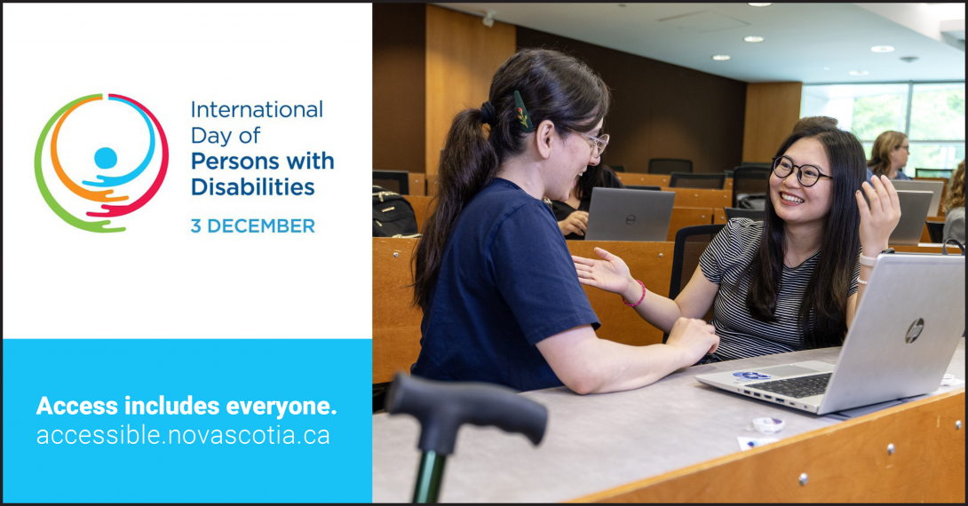 Poster for International Day of Persons with Disabilities. Two students sit at a table in a classroom talking and smiling. One gestures with her hand while the other works on a laptop. 